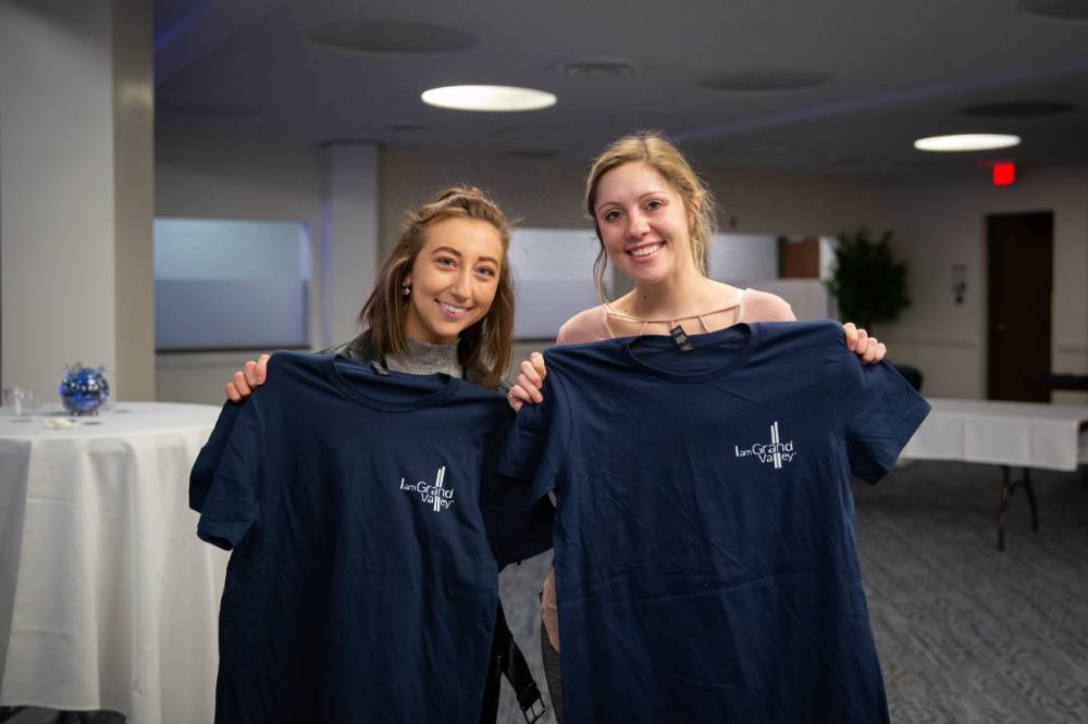 Two students posing with their I am GV shirts.